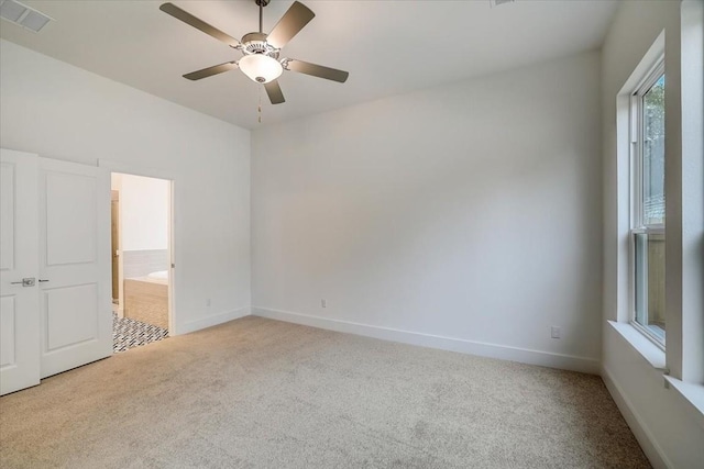 carpeted spare room with ceiling fan