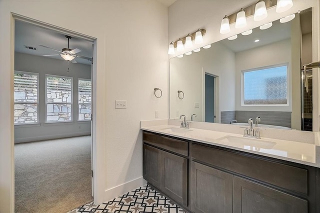 bathroom featuring ceiling fan, a bath, and vanity