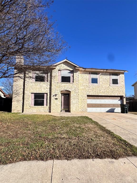 view of front of house with a front yard and a garage