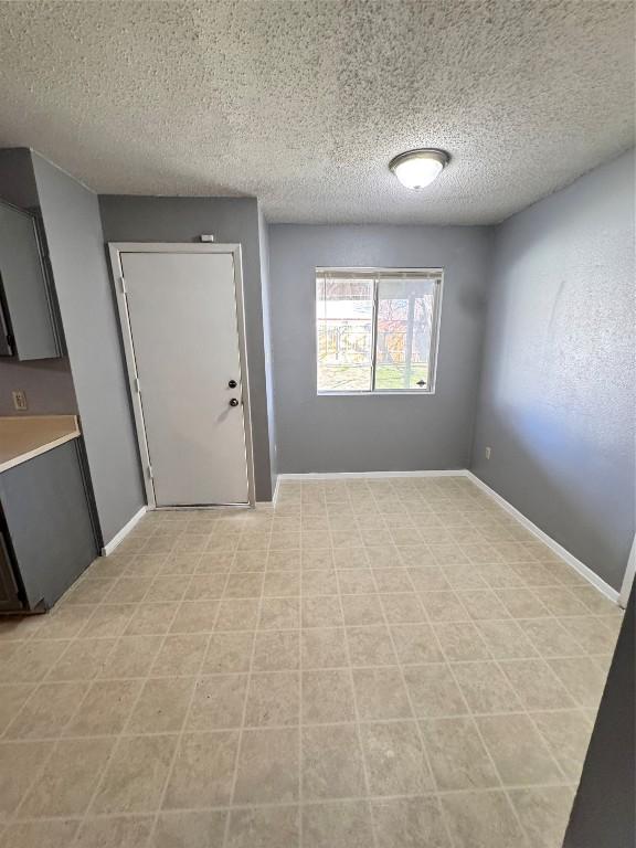 spare room with a textured ceiling