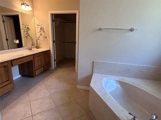 bathroom featuring tile patterned floors, vanity, and a bathtub