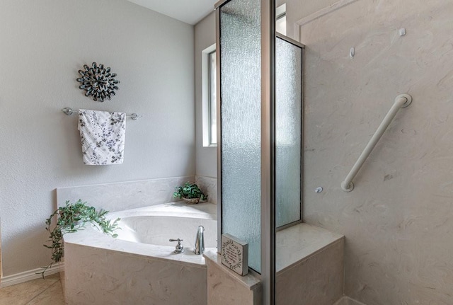 bathroom featuring tile patterned flooring and separate shower and tub