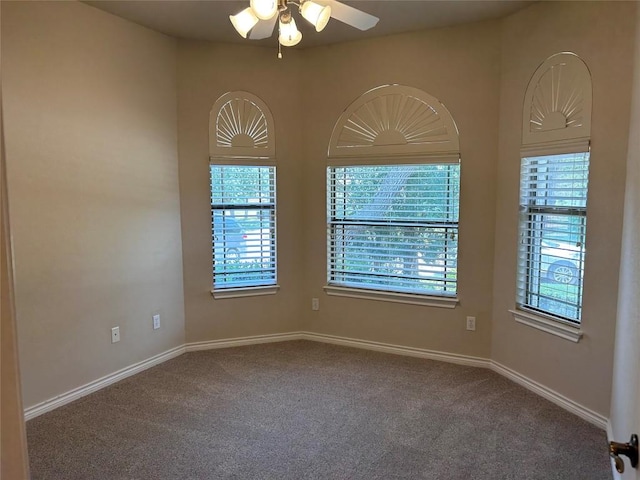 carpeted empty room featuring ceiling fan