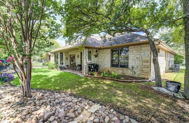 back of house with central AC unit and a lawn