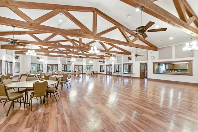 dining room featuring beamed ceiling, high vaulted ceiling, and light hardwood / wood-style flooring