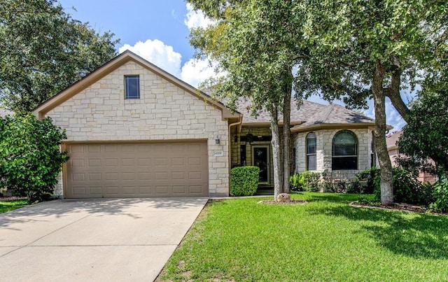 view of front facade featuring a garage and a front lawn