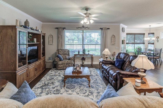 living room featuring wood-type flooring, ceiling fan with notable chandelier, and ornamental molding