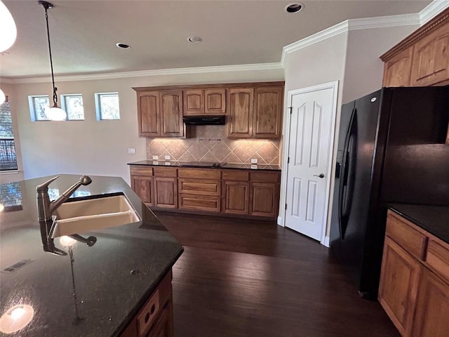 kitchen with decorative backsplash, black appliances, sink, dark hardwood / wood-style floors, and hanging light fixtures