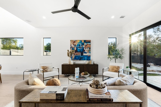 living room with ceiling fan and light wood-type flooring