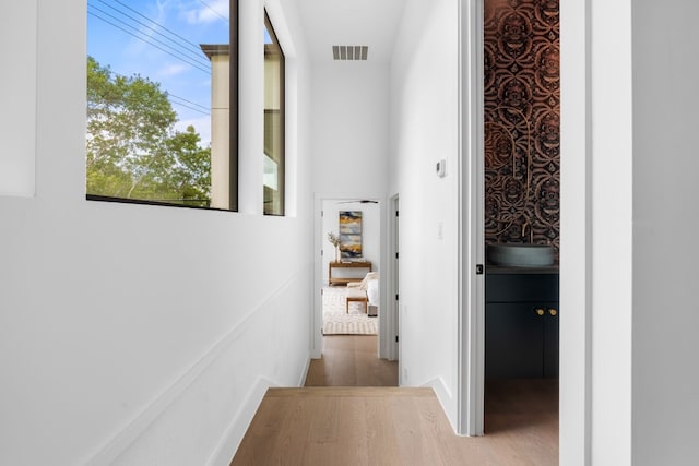 corridor with light hardwood / wood-style flooring