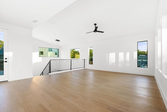 unfurnished living room featuring ceiling fan, lofted ceiling, and light hardwood / wood-style flooring