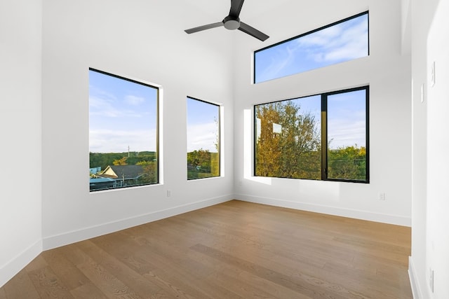 empty room with ceiling fan and light wood-type flooring