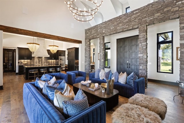 interior space with dark hardwood / wood-style flooring, a high ceiling, and an inviting chandelier