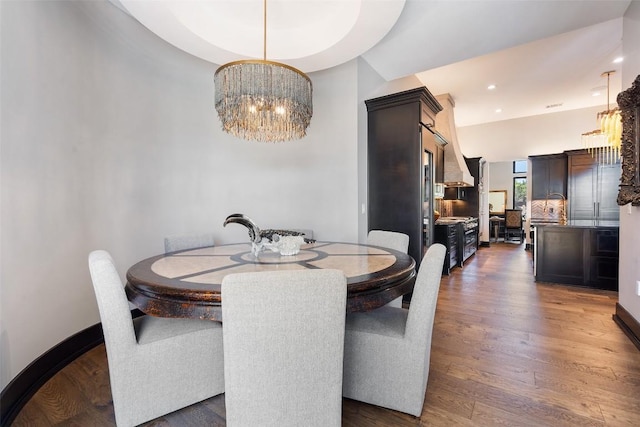 dining space featuring an inviting chandelier and dark wood-type flooring