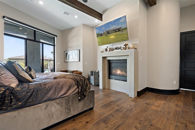 bedroom with beam ceiling, access to outside, and dark wood-type flooring