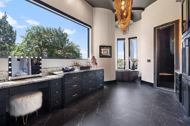 bathroom featuring a wealth of natural light, vanity, and plus walk in shower