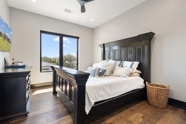 bedroom with dark hardwood / wood-style floors and ceiling fan