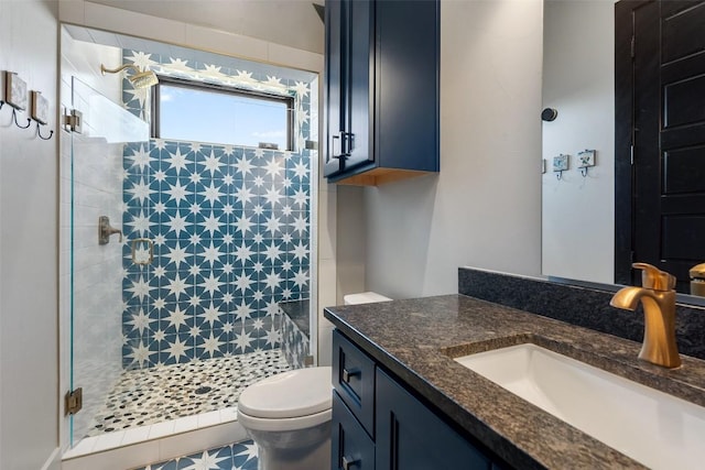 bathroom featuring vanity, an enclosed shower, and toilet