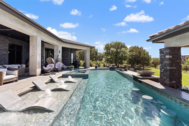 view of swimming pool with an in ground hot tub and a patio