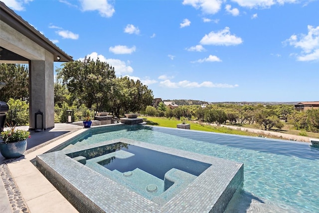 view of swimming pool with an in ground hot tub