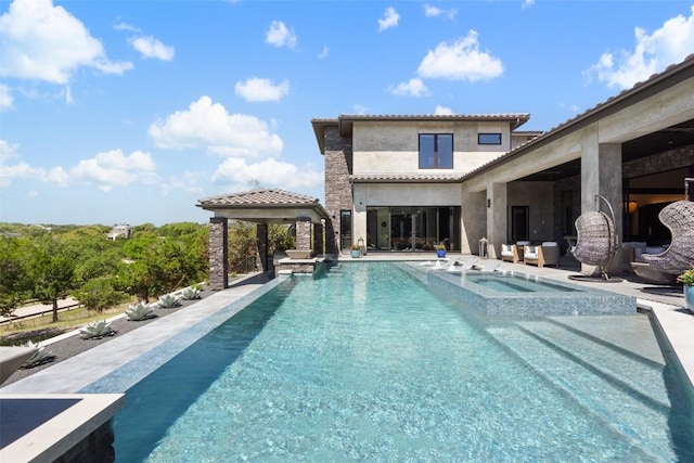 view of pool with an in ground hot tub and a patio