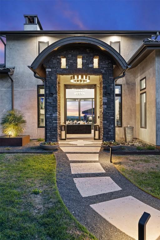 19204 Secretariat Pl, Spicewood, TX 78669 - view of exterior entry with stone siding and stucco siding