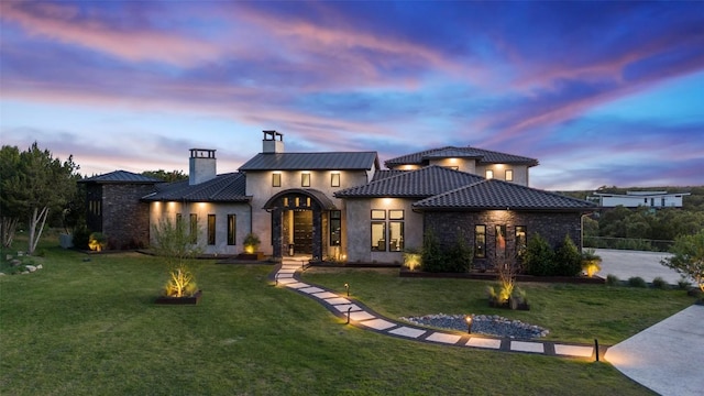 19204 Secretariat Pl, Spicewood, TX 78669 - view of front facade with a chimney, a yard, stucco siding, and stone siding