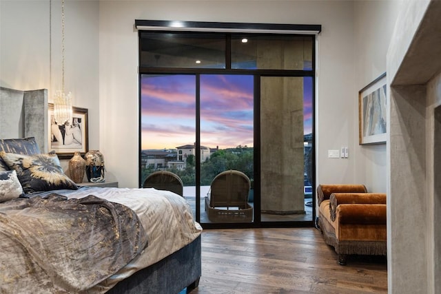 19204 Secretariat Pl, Spicewood, TX 78669 - bedroom featuring access to exterior, wood finished floors, and expansive windows