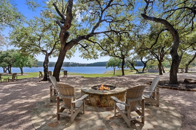 19204 Secretariat Pl, Spicewood, TX 78669 - view of patio / terrace with an outdoor fire pit and a water view