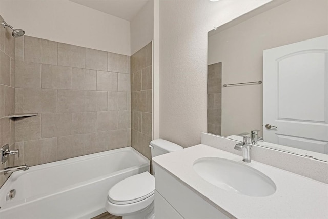 full bathroom with vanity, toilet, and tiled shower / bath