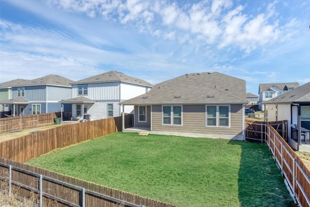 rear view of property with a yard