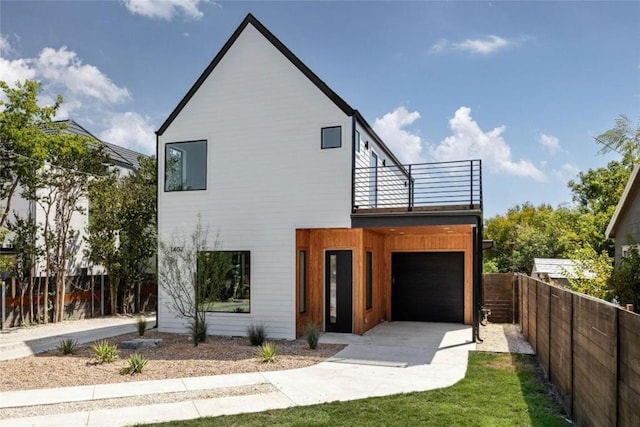 view of front of property with a balcony and a garage