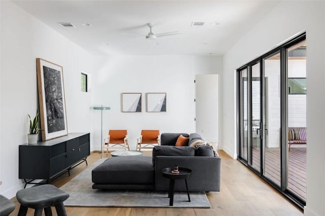 living room featuring ceiling fan and hardwood / wood-style floors