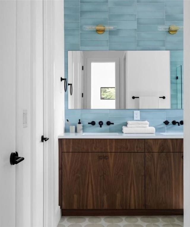 bathroom with vanity and decorative backsplash