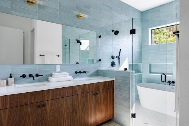 bathroom featuring vanity, tile walls, independent shower and bath, and tasteful backsplash