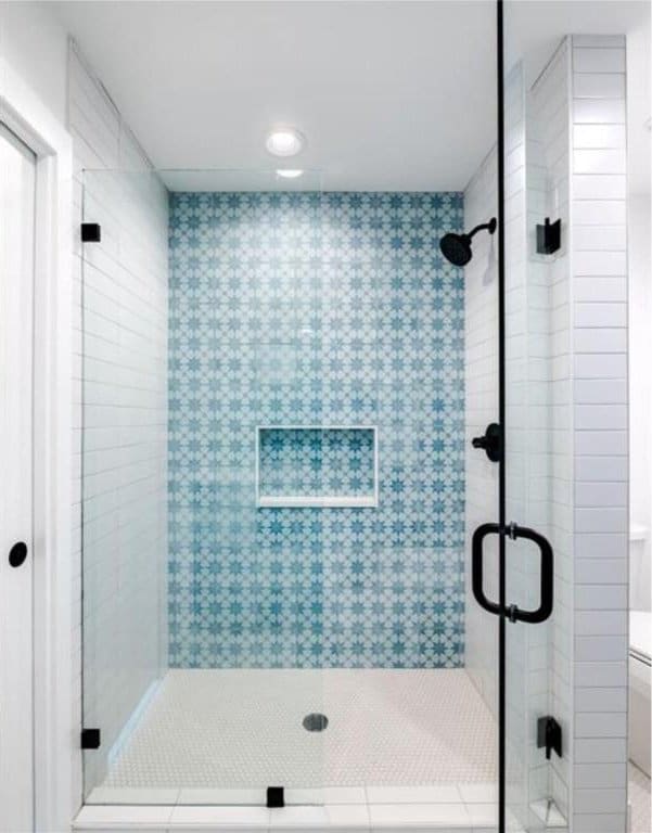 bathroom featuring tile patterned flooring, a shower with shower door, and toilet