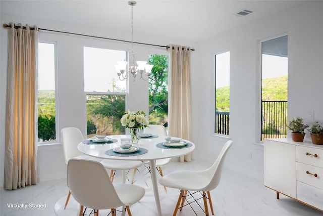 dining space with a chandelier