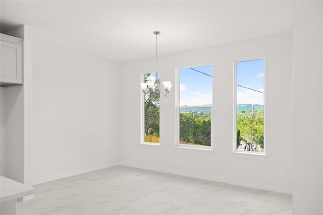 unfurnished dining area with an inviting chandelier