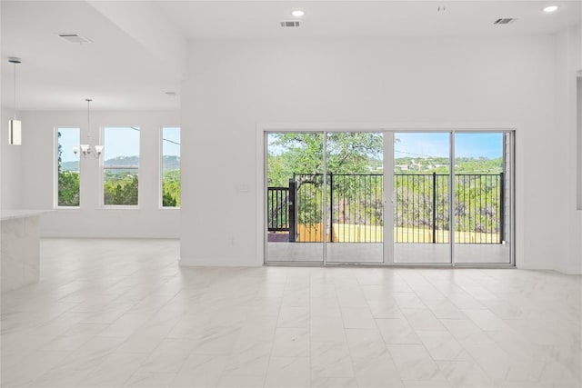 unfurnished room featuring a notable chandelier