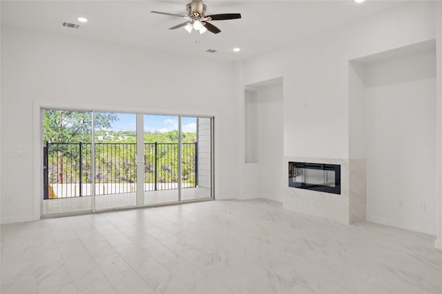 unfurnished living room with ceiling fan