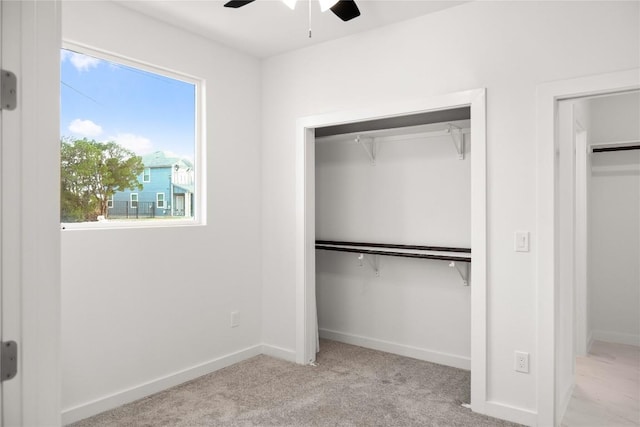 unfurnished bedroom featuring ceiling fan and light colored carpet