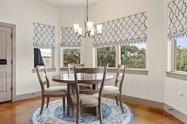 dining area with a chandelier and baseboards