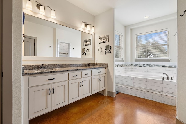 full bathroom featuring finished concrete floors, a garden tub, a sink, and double vanity