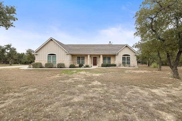 ranch-style house with board and batten siding and stone siding