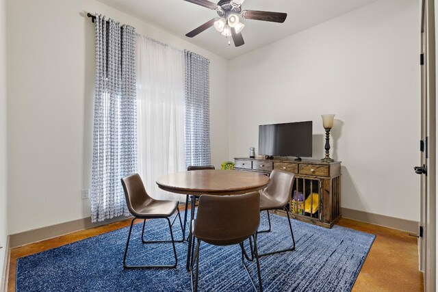 dining area with ceiling fan and baseboards