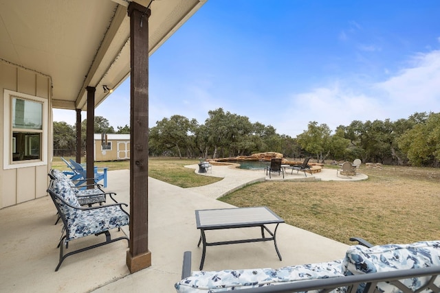 view of patio / terrace featuring a shed, an outdoor fire pit, and an outdoor structure