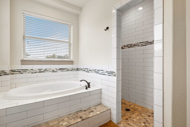 bathroom with walk in shower and a bath