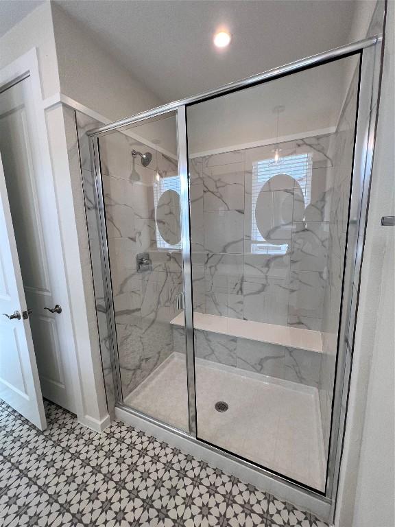 12001 Vista Parke Dr Unit 1202, Austin, TX 78726 - bathroom with a marble finish shower, tile patterned floors, and recessed lighting