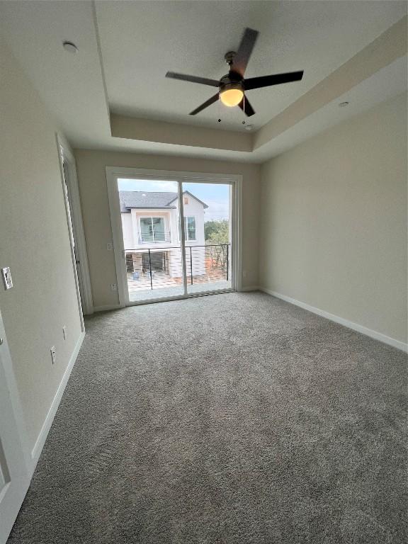 12001 Vista Parke Dr Unit 1202, Austin, TX 78726 - carpeted empty room featuring a tray ceiling and ceiling fan
