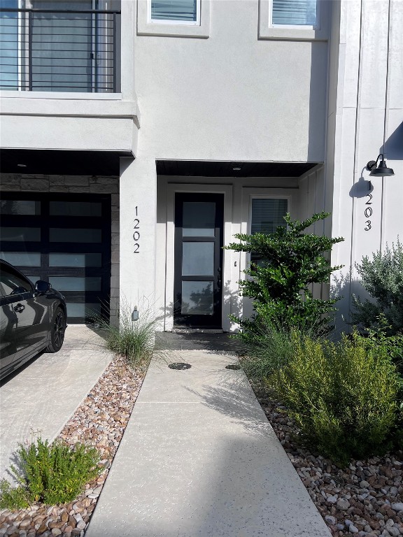 12001 Vista Parke Dr Unit 1202, Austin, TX 78726 - view of exterior entry with stucco siding